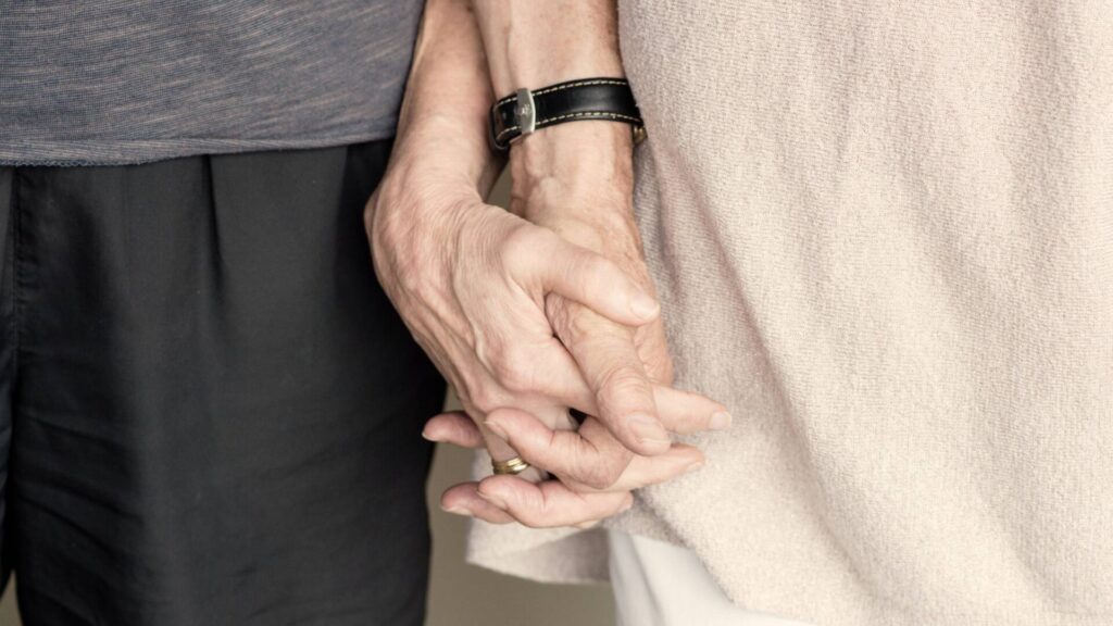 older hands holding