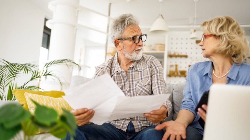older couple discuss people working sitting on sofa